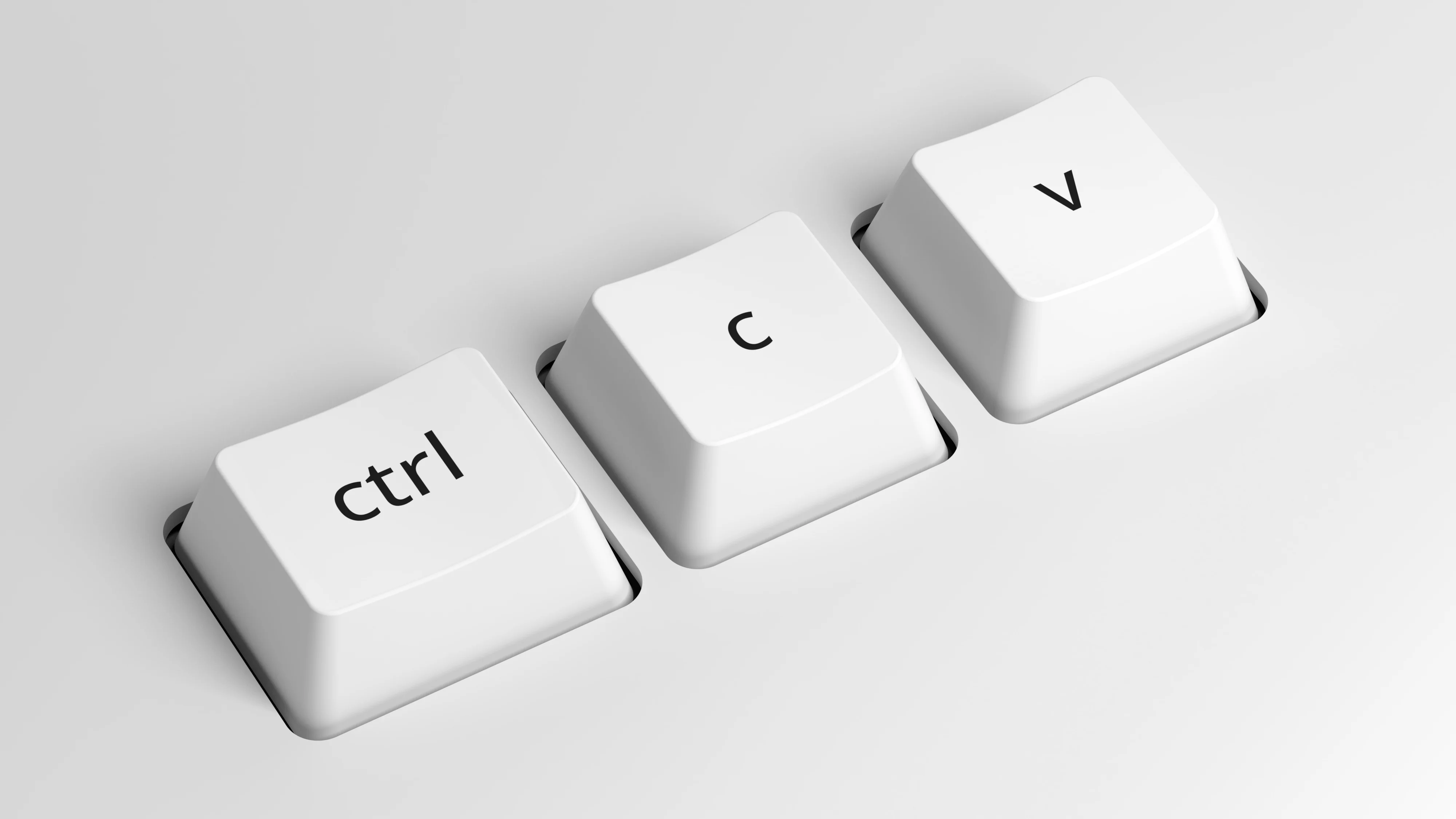 Close-up of white keyboard shortcut keys for copy, paste, and control commands